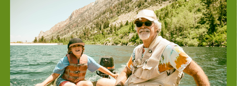 Couple in a boat on the water in front of a mountain